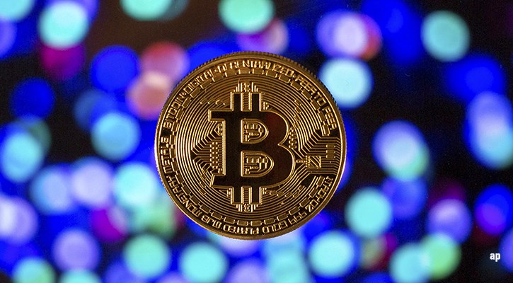 gold bitcoin on colourful background