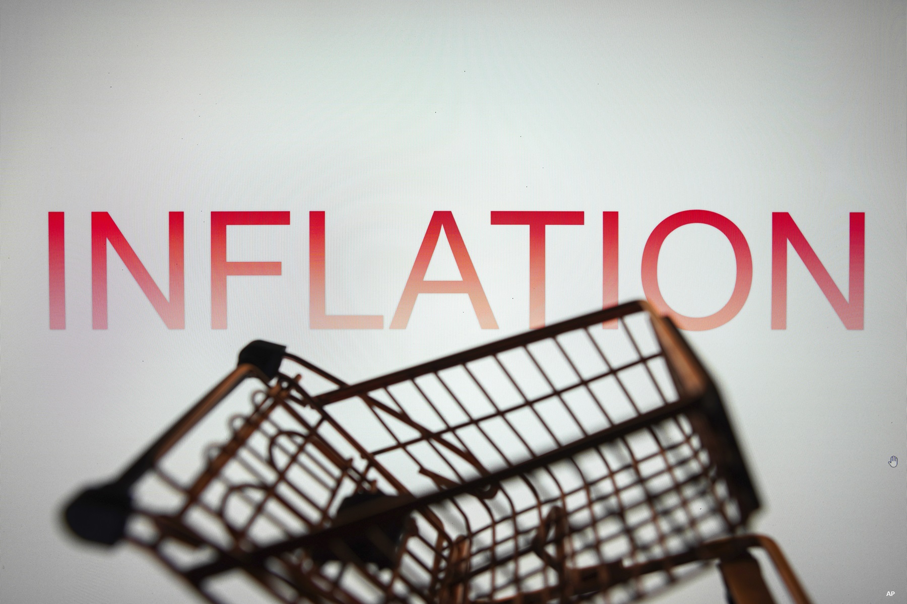 In this photo illustration, the Inflation text seen displayed on a smartphone along with a shopping cart.