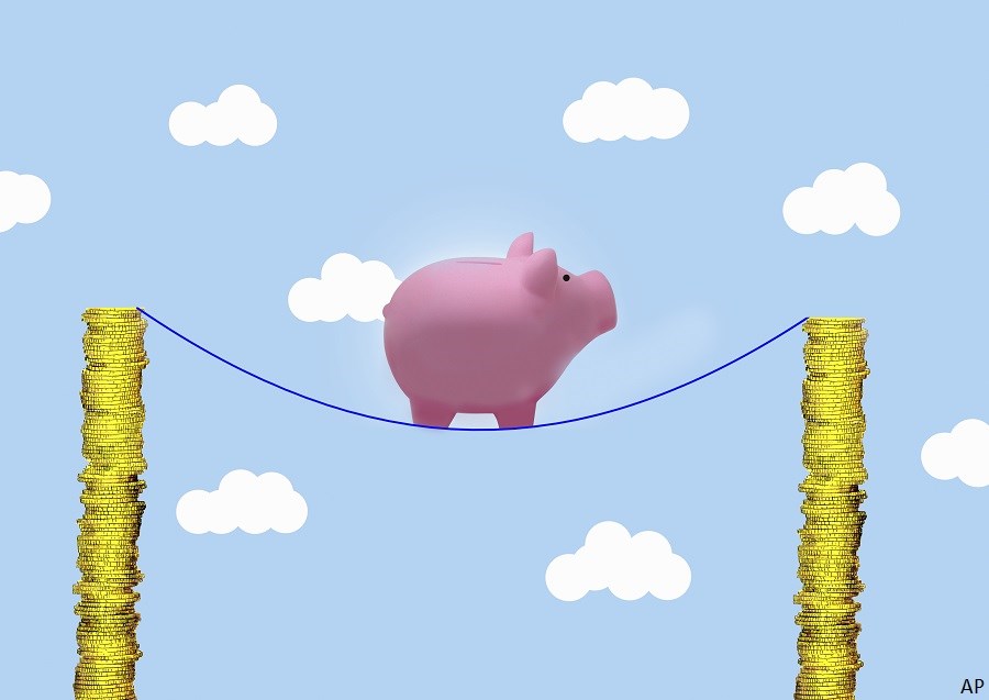 piggy bank on tightrope