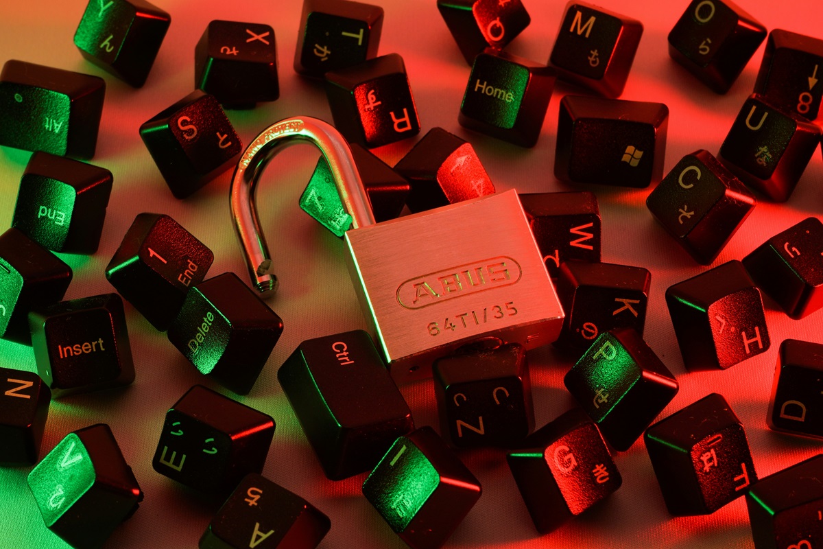 Broken keyboard and open lock illustrating cybercrime