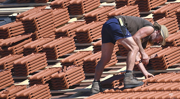 man on the roof of a new house